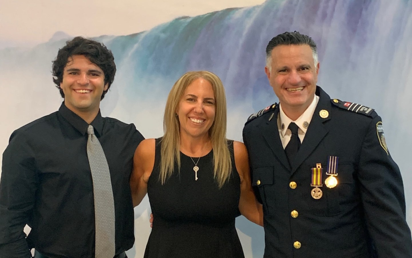 Jason Benaim in service dress with his son Aiden and wife Melissa at the Ontario Association of Paramedic Chiefs' 2026 gathering in Niagara Falls